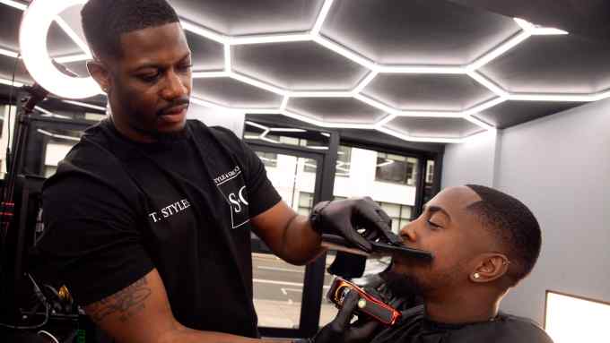 Thomas “T Styles” Yeboah, barber, stylist and founder of Style & Groom, working in his salon