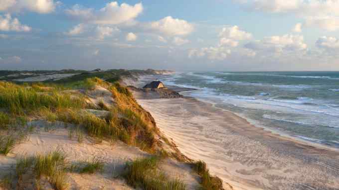 Sand dunes, a beach and the sea